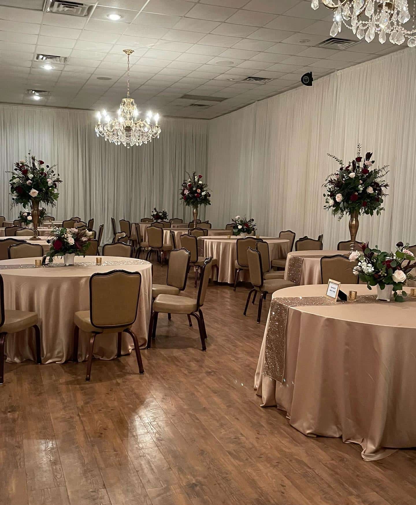 Banquet room set for a reception with florals